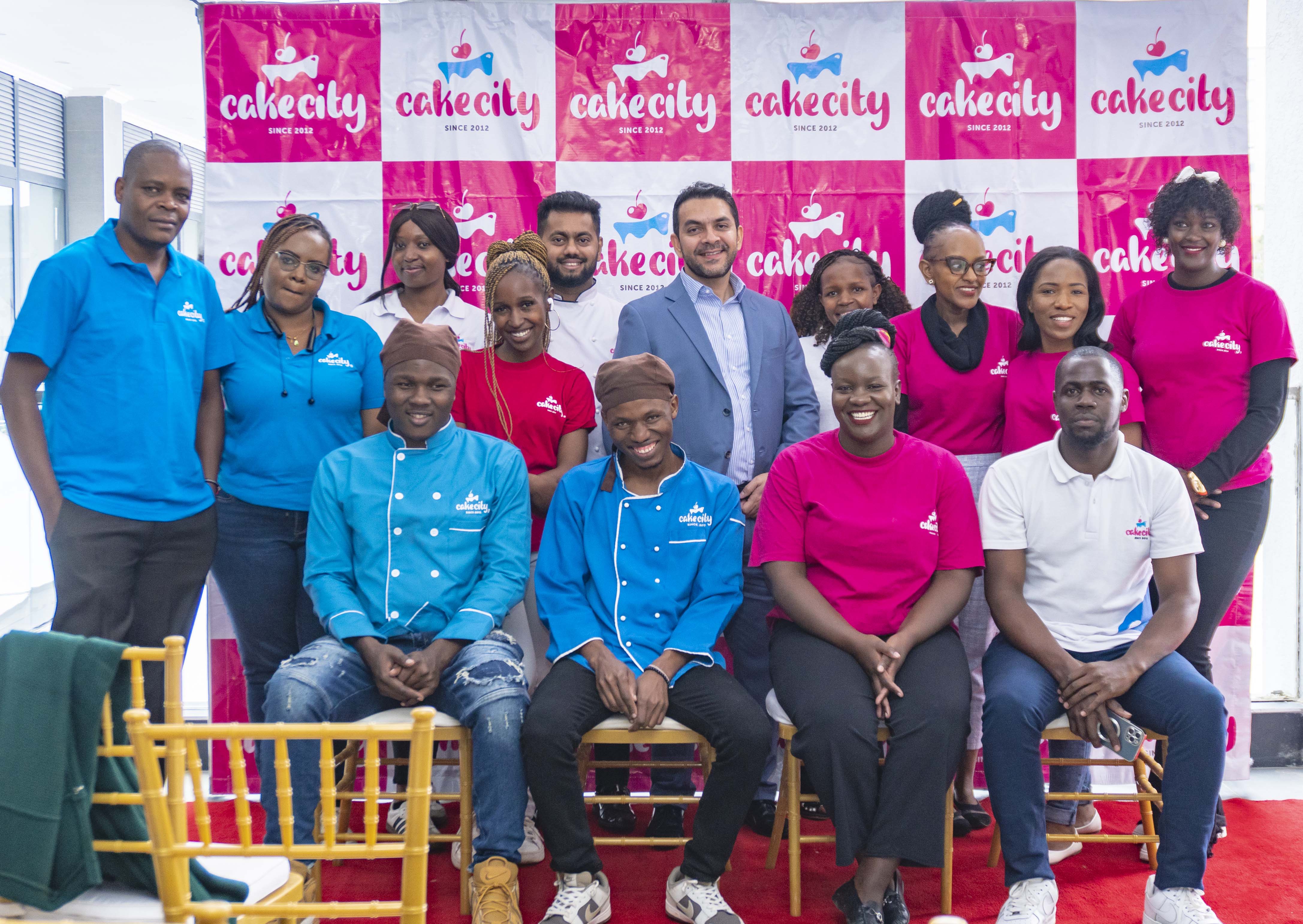 cake city staff posing with the CEO Zahir Mohammed for a photo during the launch